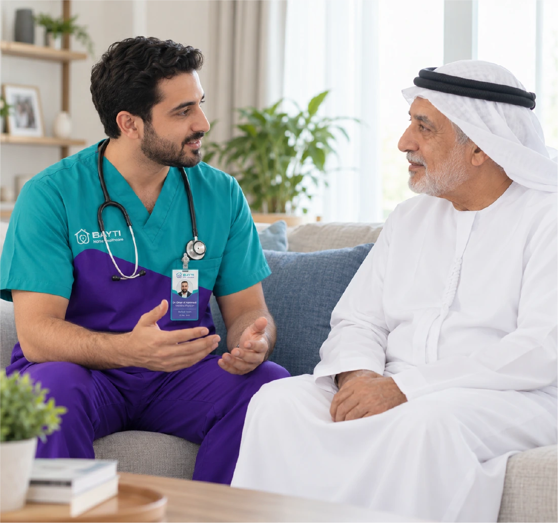 A Bayti physician sitting with a patient in his living room, talking through his care
