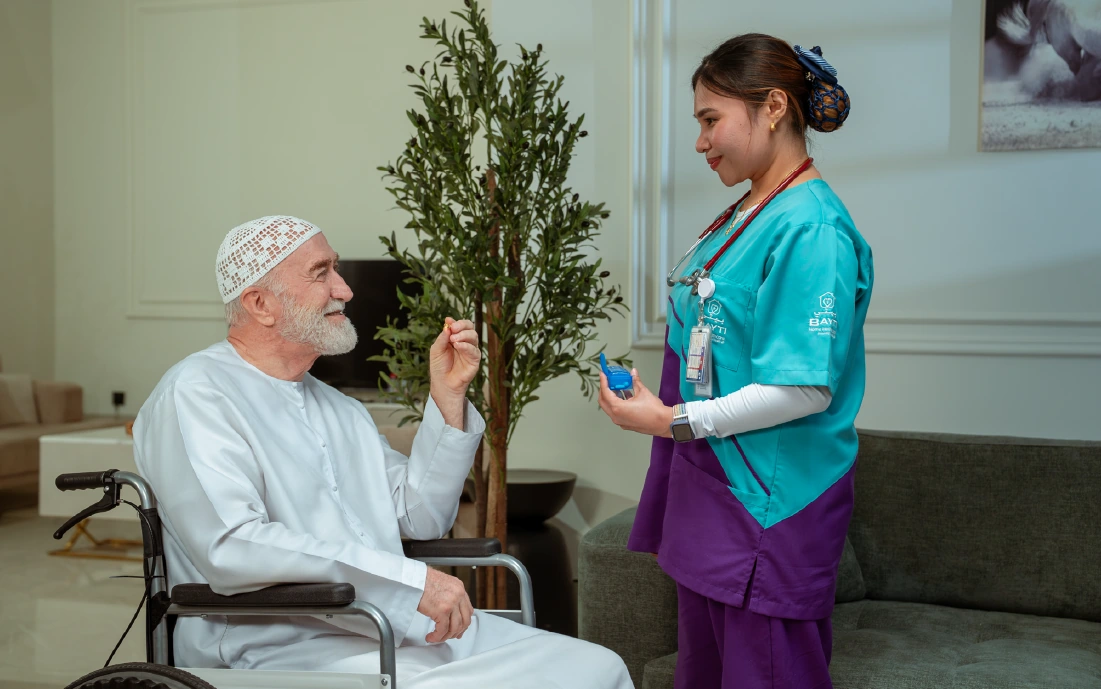 A Bayti nurse helping a client at home
