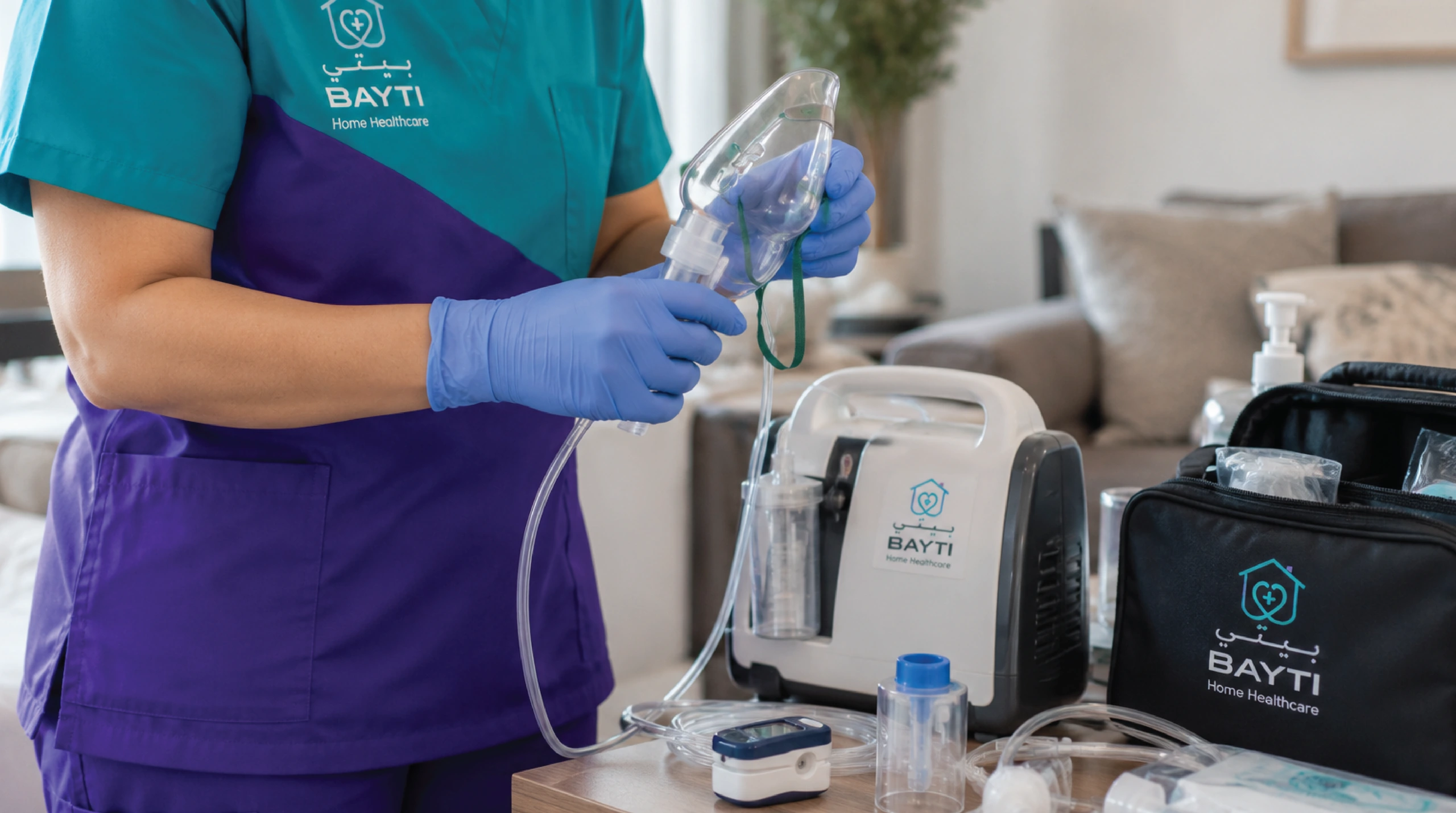 An oxygen concentrator and a portable ventilator standing beside an armchair at home